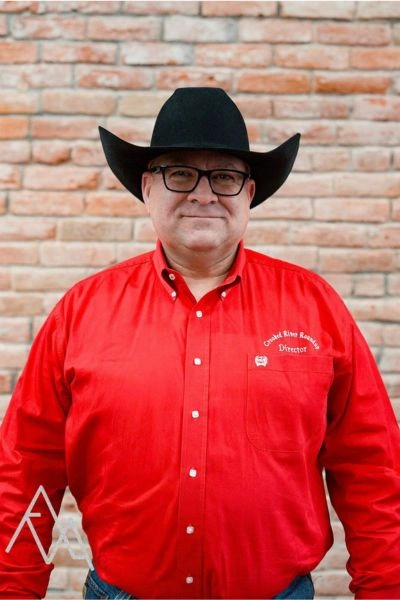 Photo of Jeff Papke in red CRR oxford with black hat and black glasses