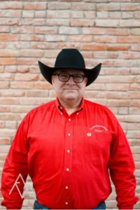 Photo of Jeff Papke in red CRR oxford with black hat and black glasses